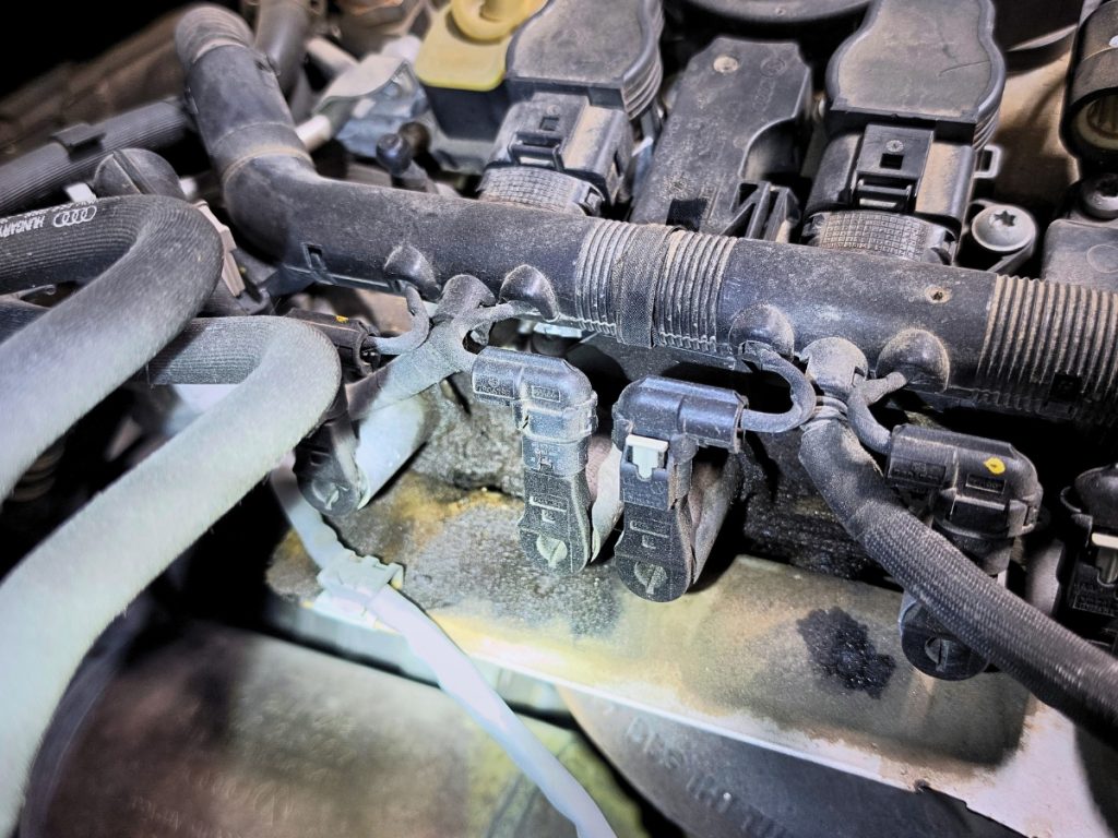 Oil leaking around the camshaft-cover area of a 2017 Audi Q5 with a failed PCV valve