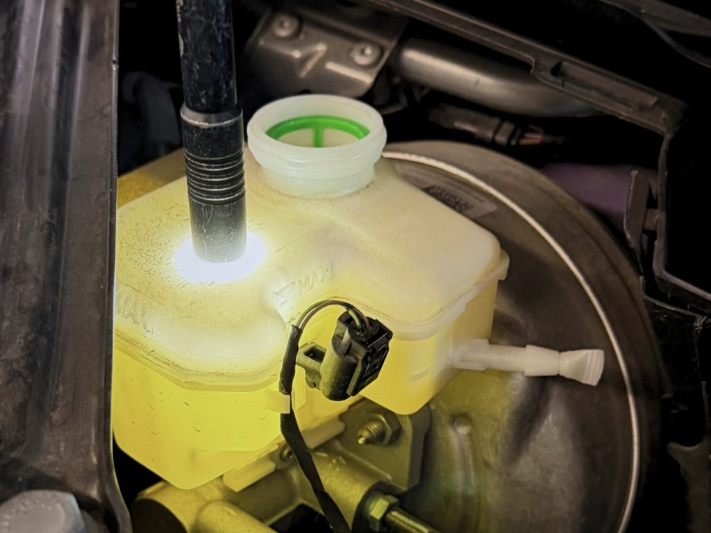 BMW brake fluid reservoir inspected during maintenance at Westgate High Tech Auto Care in Omaha, NE.